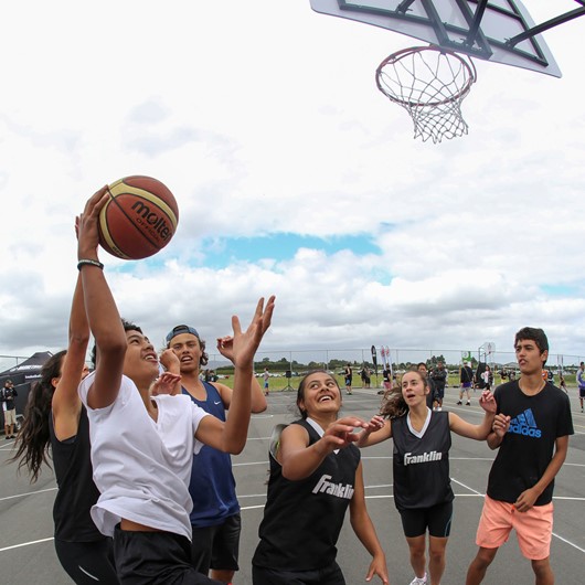 Boys and girls playing school basketball image