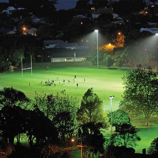 Looking over at a football pitch in the distance at night image