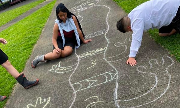 Students drawing on footpath