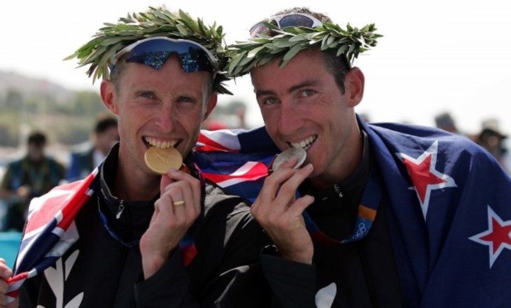 two men posing with medals 