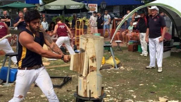 Guy chop wood at Axemen competition