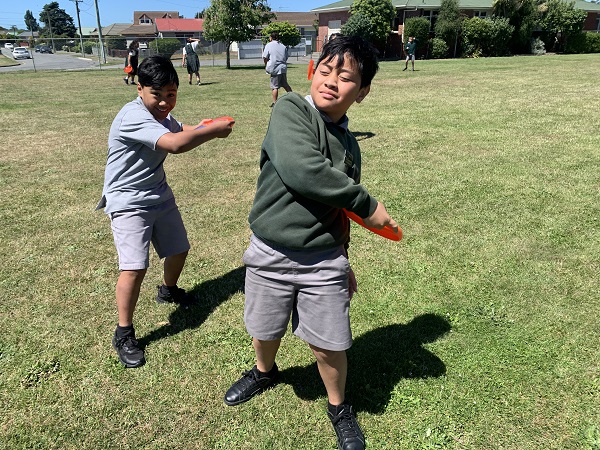 Two kids preparing to throw a frisbee