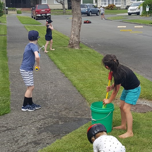 Kids playing in their neighbourhood street image