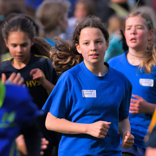 Young women running in a group