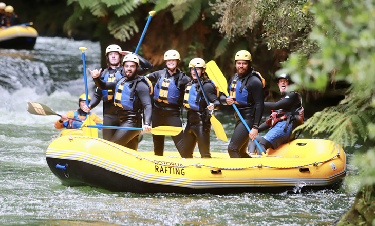 River rafters pose for a photo on the water