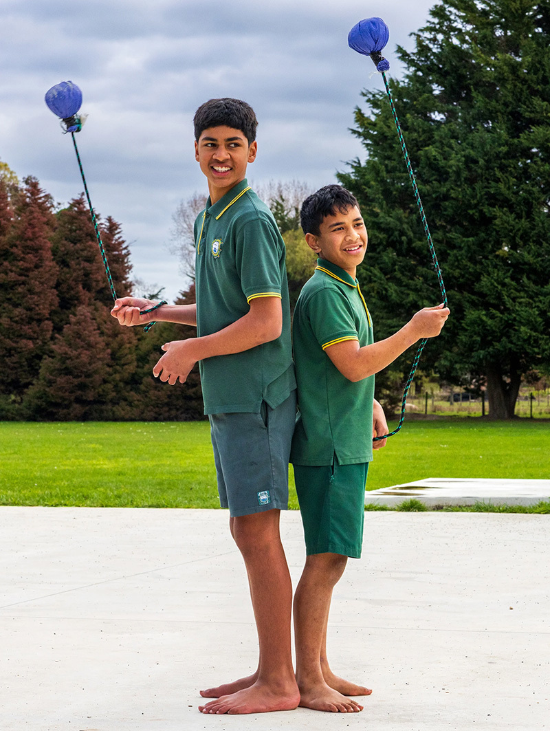 Two boys swiming poi