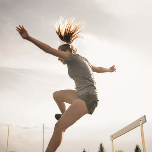 Girl jumping during a steeplechase