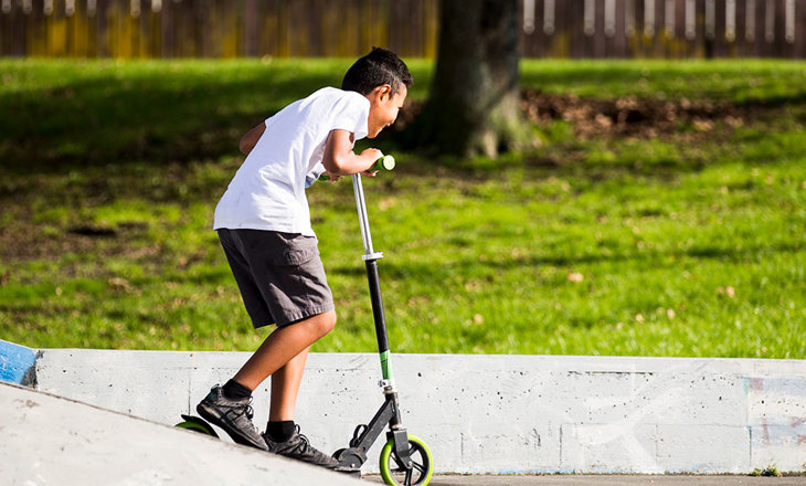 Boy riding a scooter