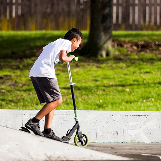 Boy riding a scooter image