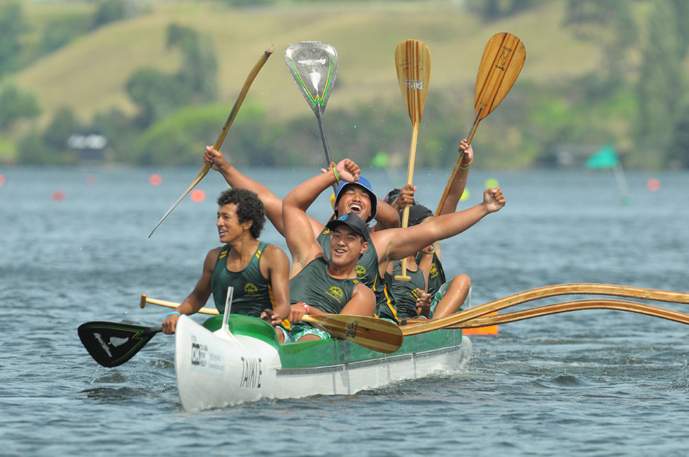 Boys celebrate after racing waka to victory