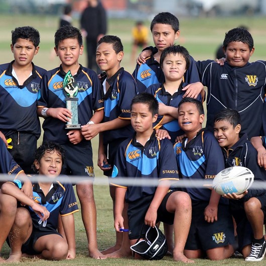 Rugby league team of tamariki pose for a team shot