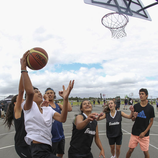 Boys and girls playing school basketball