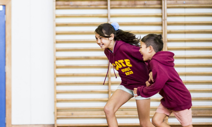 Girl and boy racing each other in the gym