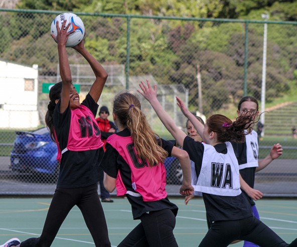 young women netball players playing netball