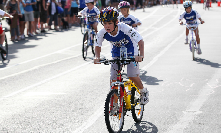 Tamariki boys on bmx bikes racing on the road