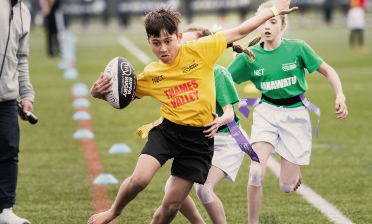 Boy in Thames Valley tshirt running with rugby ball