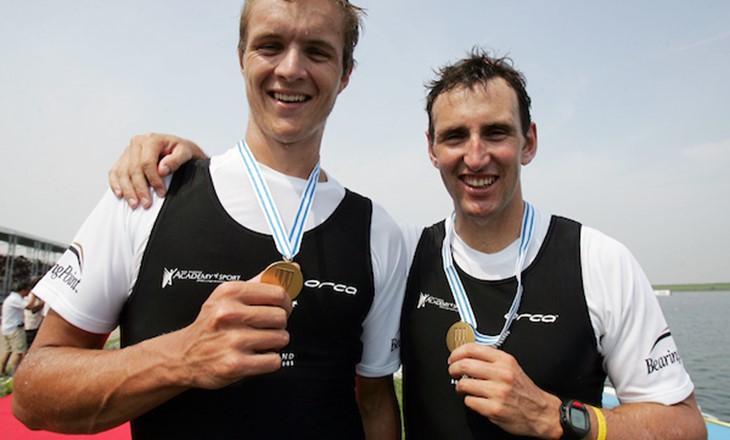 Two rowers pose with their medals