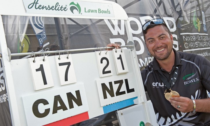 Player stands by scoreboard at World Lawn Bowls final