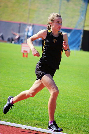 Izzy Hegan running on a track