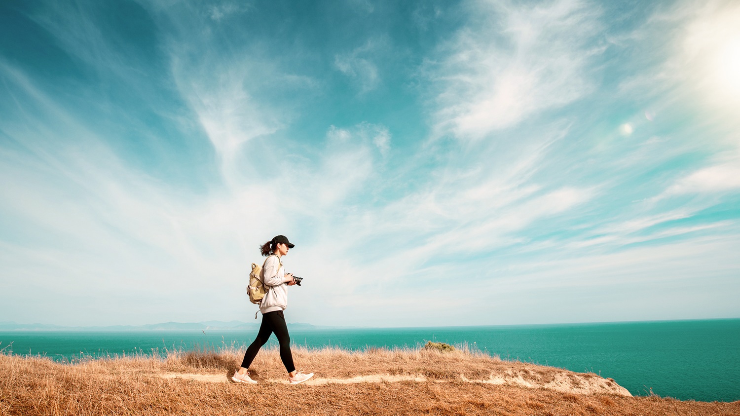 Girl walking on the edge of a cliff