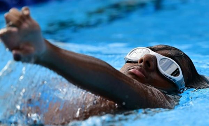 Child doing backstroke in a swimming pool