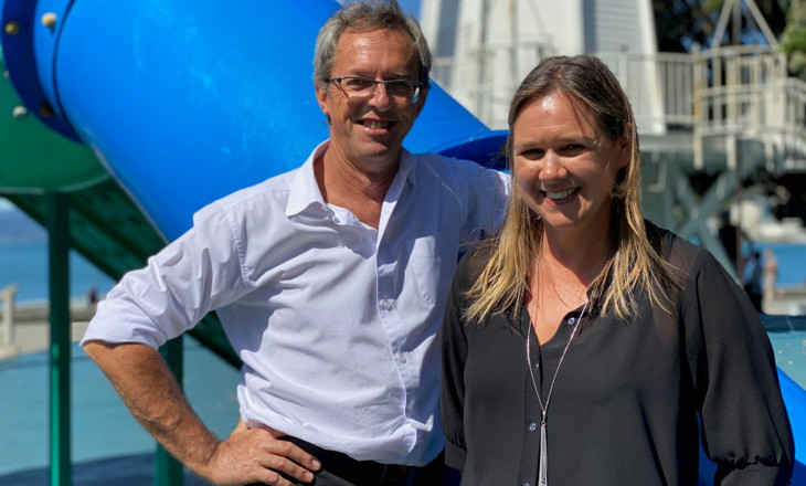 Roger Wood and Celia Fleck standing in front of a slide