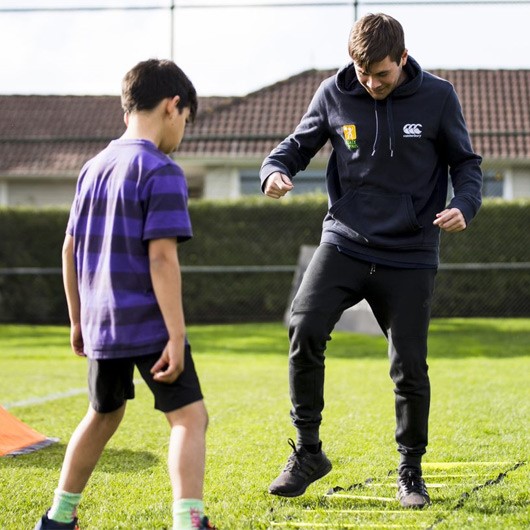 Volunteer coaching a young player