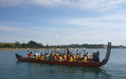ActivAsian team with oars raised on waka