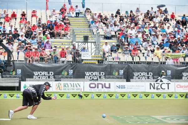 A competitor just releasing the ball at a bowls tournament