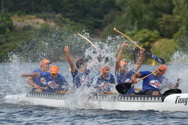 A team celebrates at a Waka Ama race