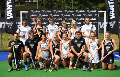 Hockey team posing for a photo in front of the goal