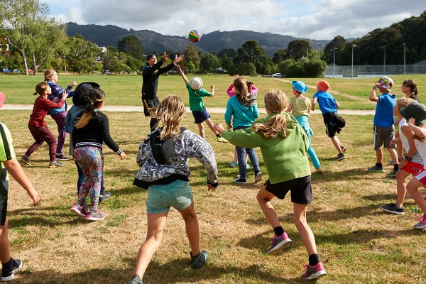 Kids playing with a ball on a field