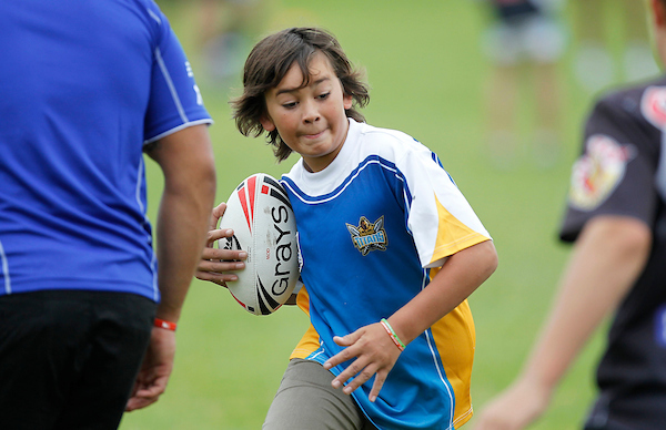 a young boy playing rugby