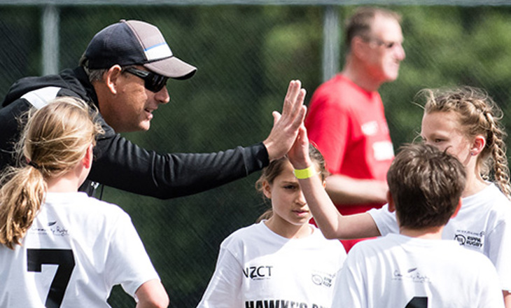 Rippa rugby coach high fiving a girl player