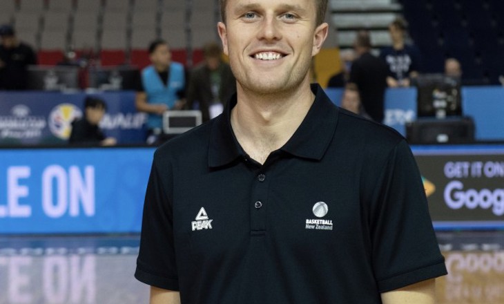 Photo of Conor Gilchrist standing on a basketball court