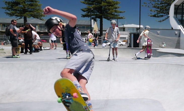 A boy on his skateboard at a skatepark