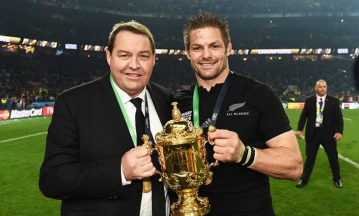Steve Hansen and Richie Mccaw hold trophy on field