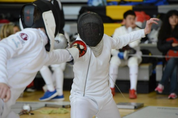 Two people fencing