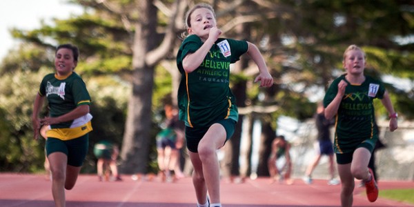 Three children on a running track