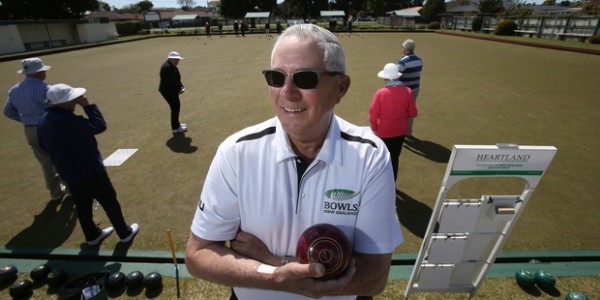 Man smiling at camera at a bowls tournament
