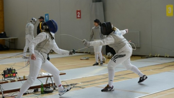 Two opponents at a fencing competition