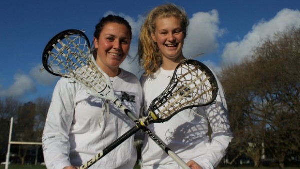 Two young women holden lacrosse raquets