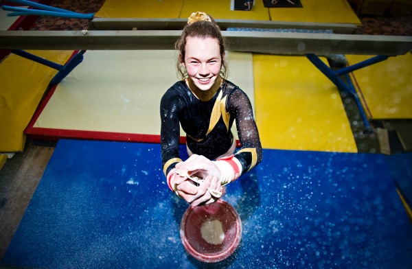 Emma Larsen preparing for a bar routine in gymnastics