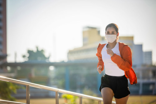 Women in mask jogging