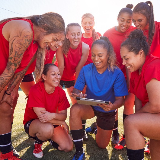 Image of coach with secondary school age female athletes image