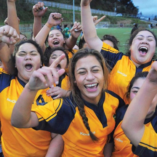 Team of wahine with arms raised in triumph