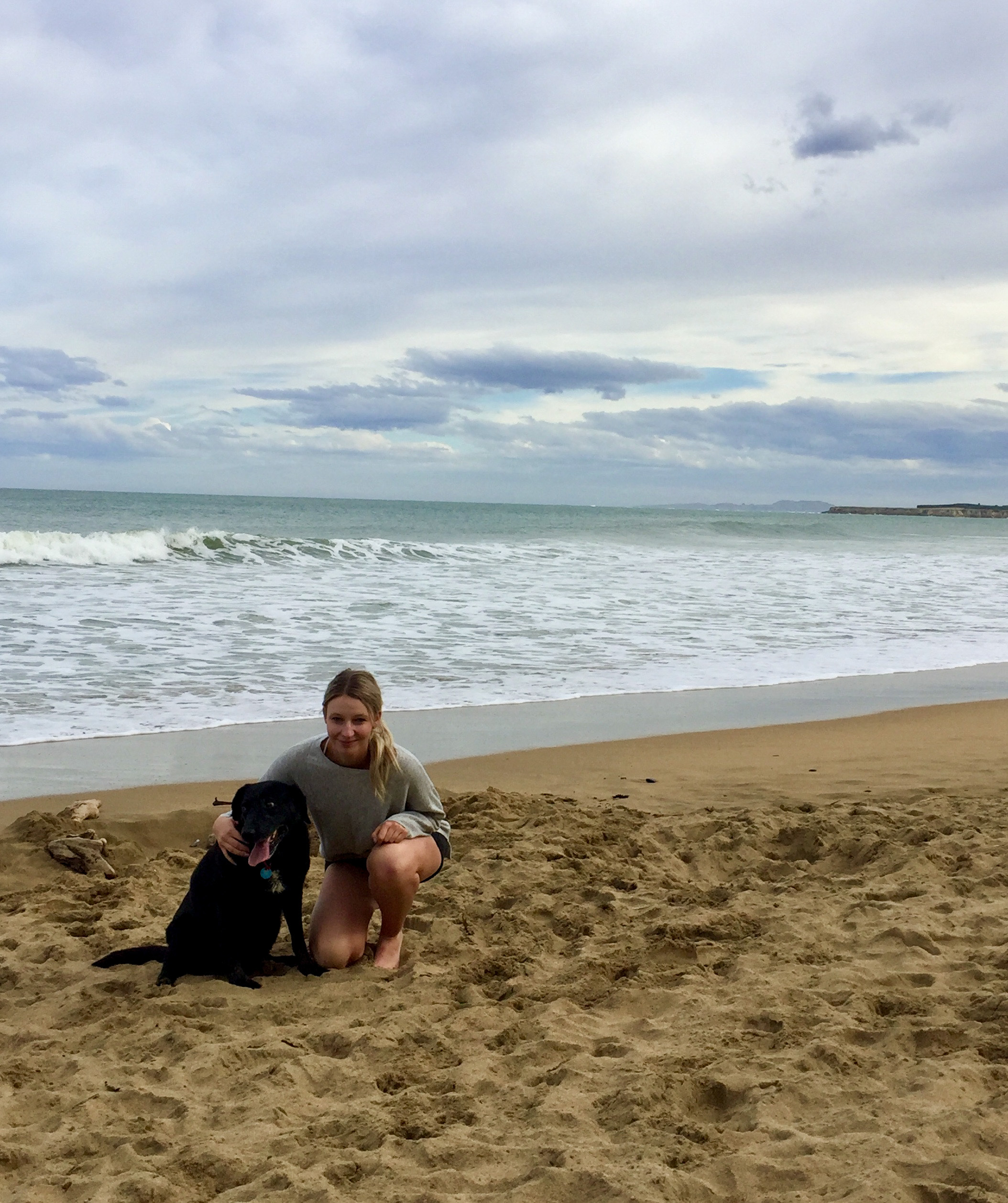 girl with a dog on a beach 