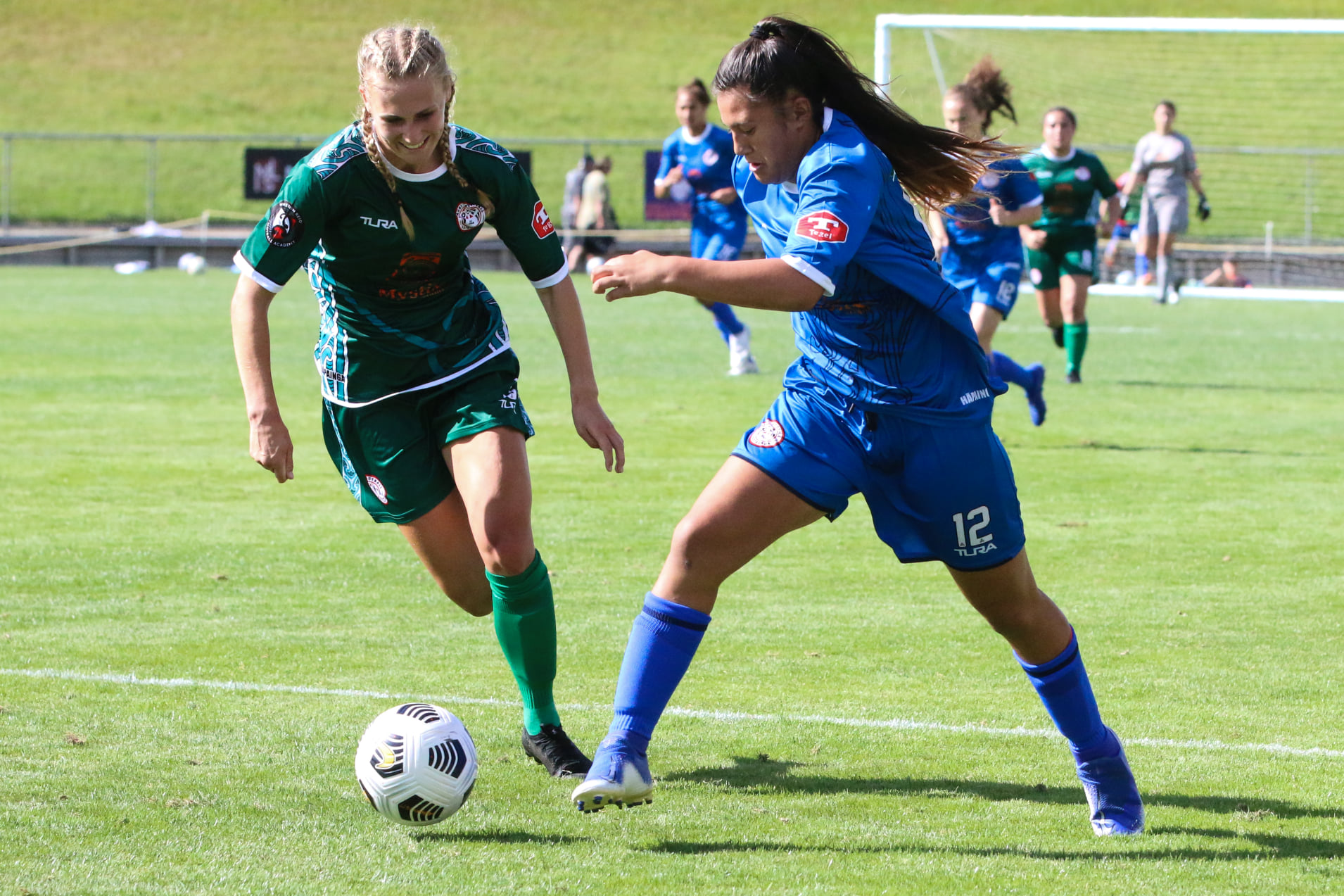 two young women footballers at a football game