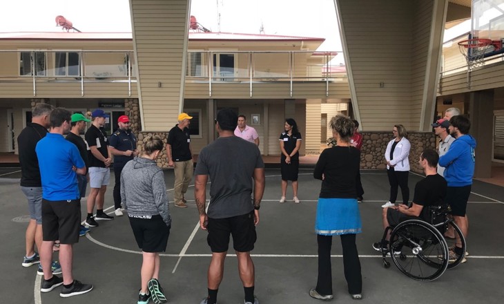 A group form a circle on a basketball court
