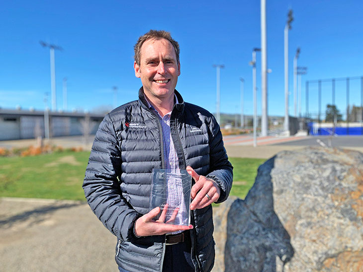 Man posing with a trophy 